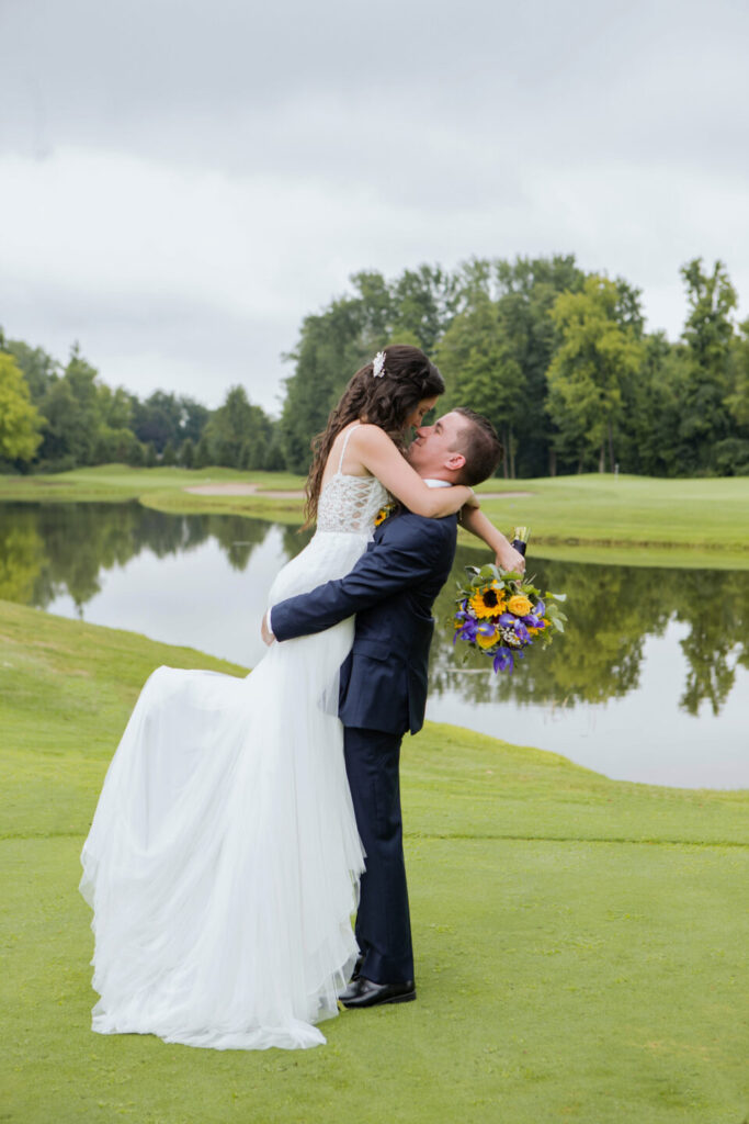 Bride and groom in front of pond