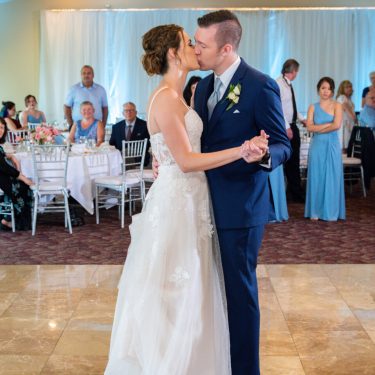 Married couple kissing on dance floor in MI