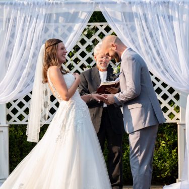Couple laughing while getting married
