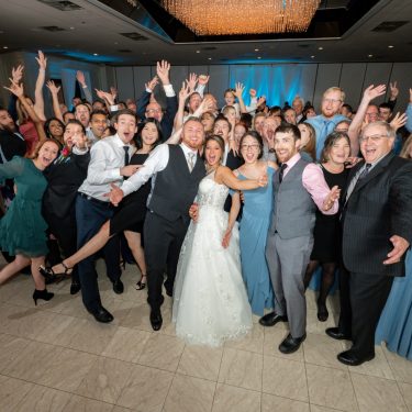 Wedding guests on dance floor with bride and groom