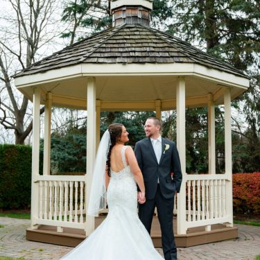 Bride and groom in front of gazebo