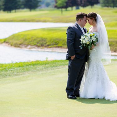Bride and groom on golf course in MI
