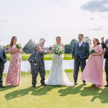 Bridal party in light pink on golf course in MI