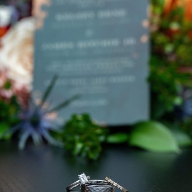 Wedding rings on dark wood table