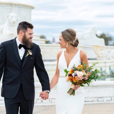 Married couple in front of stone fountain