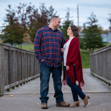 Couple in front of a wooden bridge